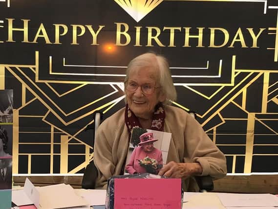 Joyce Wooding pictured on her 109th birthday with her card from HM The Queen.