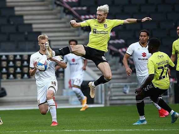 Ryan Watson in the thick of the action at Stadium MK (Pictures: Pete Norton)