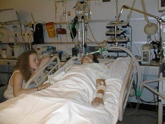 Hayley pictured waiting by Natasha's bedside after her heart and lung transplant in 2001.