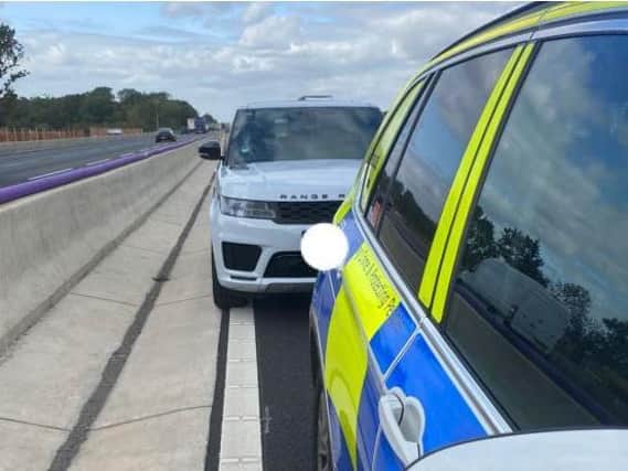 Police vehicles stopped the white Range Rover on the M1. Photo: Northamptonshire Police ARV