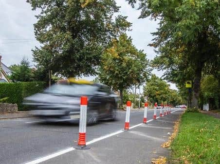 The orange temporary traffic wands have caused a strong reaction from residents in Rushmere Road. Pictures by Kirsty Edmonds.