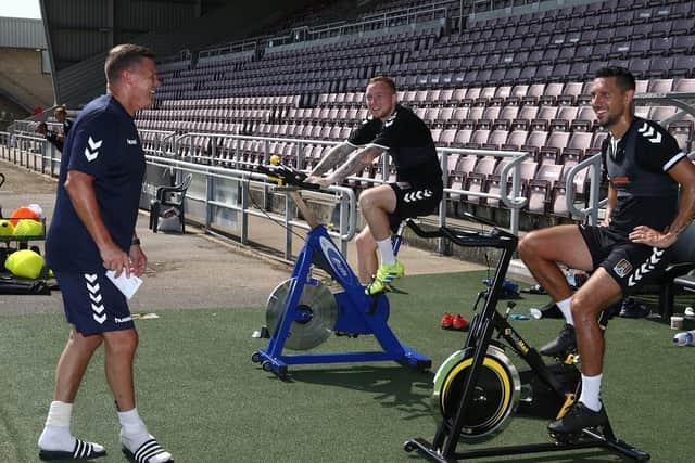Northampton Town FC players Nicky Adams (centre) and Joe Martin pedal for Cynthia Spencer Hospice with assistant manager Colin West