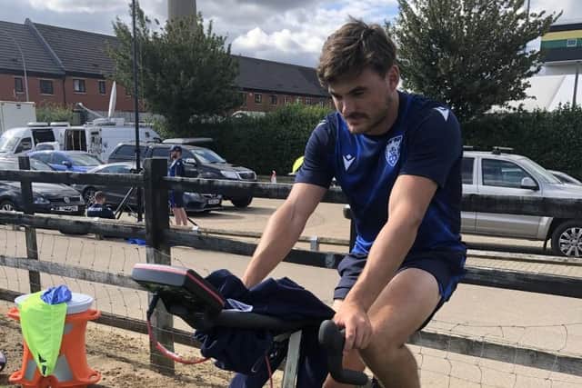 Northampton Saints and England fullback George Furbank on the static bike for Cycle4Cynthia