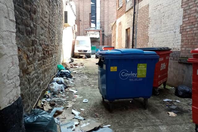 Rubbish has been strewn all along the side of the alley on Sheep Street