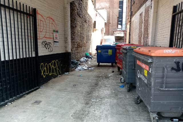 Rubbish has been strewn all along the side of the alley on Sheep Street