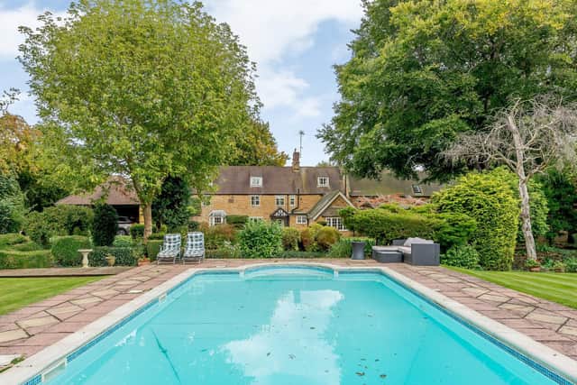 A huge outdoor pool that is heated is a selling point for the home.