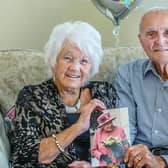 The happy couple, Joan and Roy King, pictured smiling and holding up their anniversary card from the Queen. Pictures by Kirsty Edmonds.