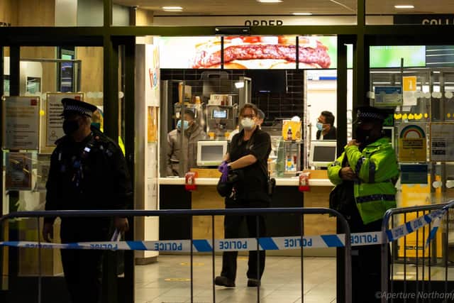 Forensic experts gather evidence inside McDonald's after a 17-year-old was stabbed on Wednesday night