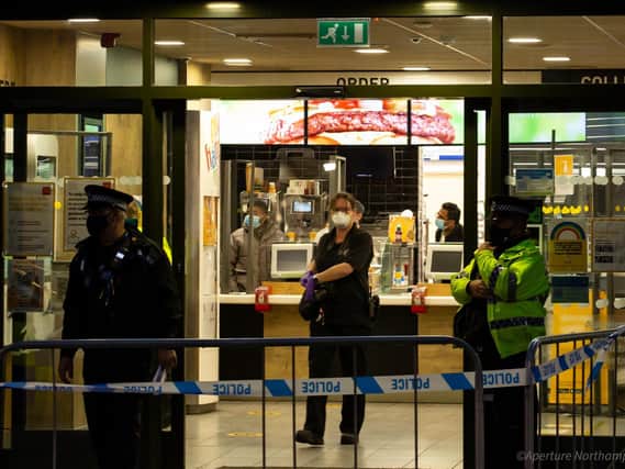 Forensic experts gather evidence inside McDonald's after a 17-year-old was stabbed on Wednesday night