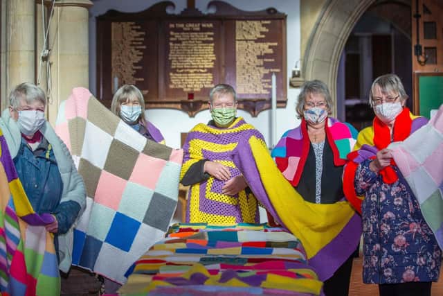 Christine Goodger, Pam Ashley, Father Antony, Viv Stibbards and Rosemary Tew pictured draped in their handmade blankets which have taken them seven months to make.