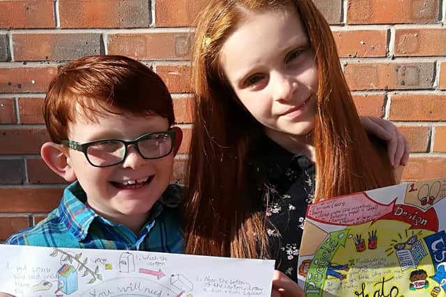 The siblings with their winning posters.