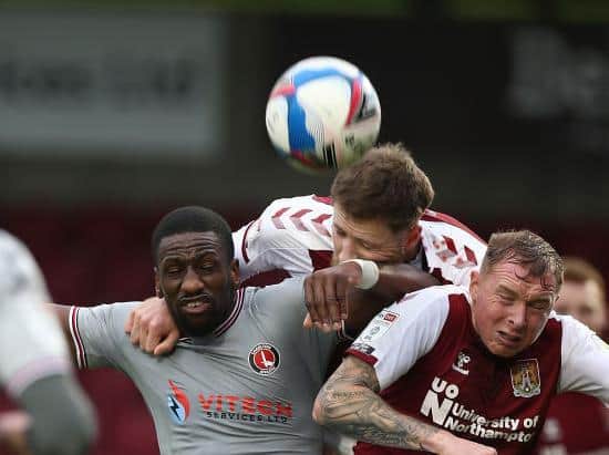 Fraser Horsfall and Nicky Adams battle with Charlton striker Omar Bogle (Pictures: Pete Norton)