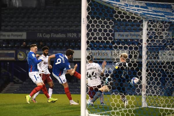 John Marquis slots home Portsmouth's opening goal in their 4-0 win over the Cobblers at Fratton Park on Tuesday night