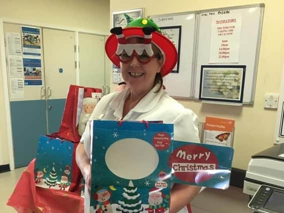 Brampton Ward nurse Jane Drew pictured in 2019 with a Christmas goodie bag.