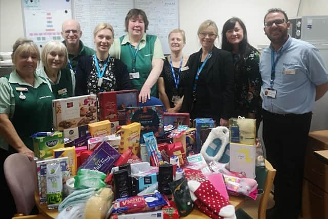 The domestic team pictured with a table heaped with donations ready to hand out.
