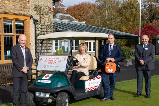 Presenting the 'medi-buggy' to the club are (left) Mark Danis, commercial director Avery Hawthorns Group, and (right) David Seward, general manager of the Hawthorns independent senior living community in Northampton, where several of the residents are still active members of the golf club. Pam Oliver, whose husband fell ill on the course last year, is in the driving seat.