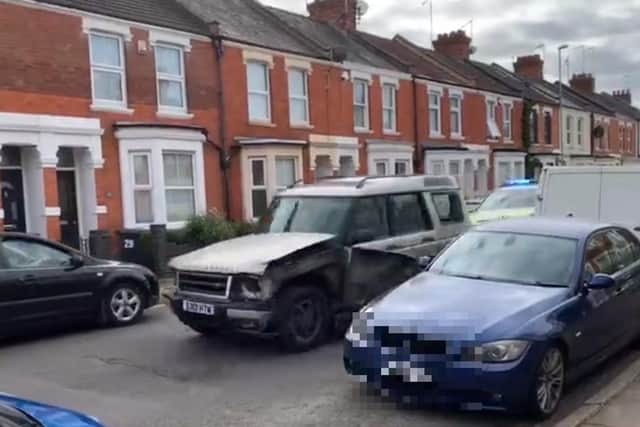 Parker - see driving this gold Land Rover Discovery - was caught on camera by shocked residents as he tore through Abington.