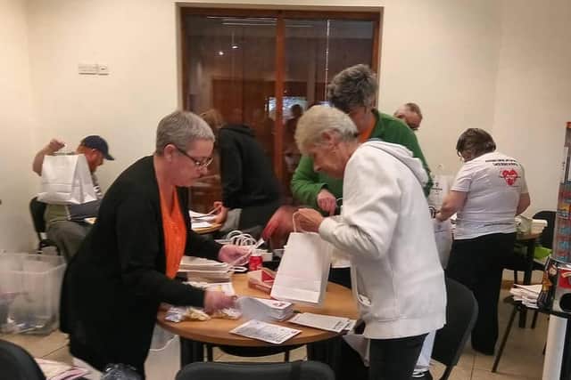 Lynette and her mum volunteering at The Lewis Foundation packing night last year.
