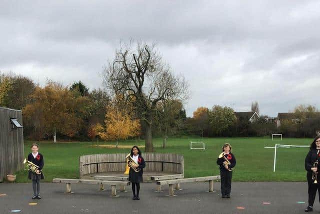Left to right: Teacher John Bickerdike,Year 6 pupils, Norah Davies, Ana Ackbarally and Toby Somers and local trumpet player Kim Sheriff.