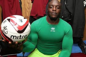 Adebayo Akinfenwa shows off the signed match ball following the Cobblers' 4-2 win at Accrington in November, 2012