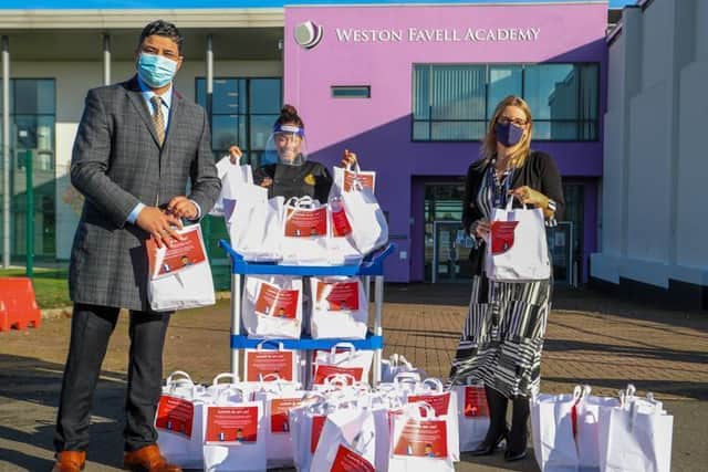 Saffron staff handing over the meals to teachers at Weston Favell Academy