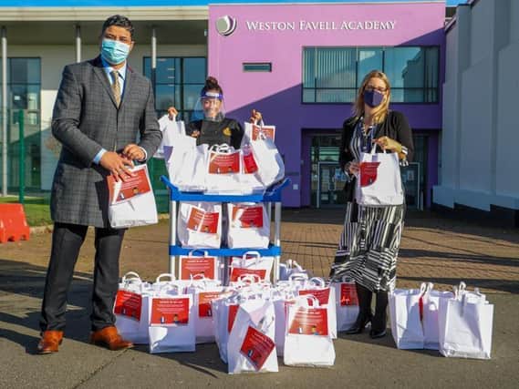 Saffron staff handing over the meals to teachers at Weston Favell Academy
