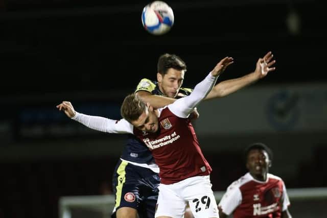 Former Cobblers defender Luke Prosser beats Danny Rose in the air