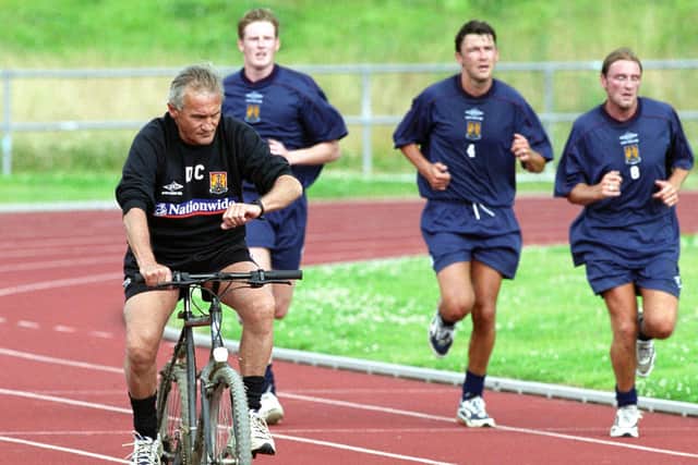 Ian Sampson is put through his paces by Denis Casey in a pre-season on the old Sixfields athletics track