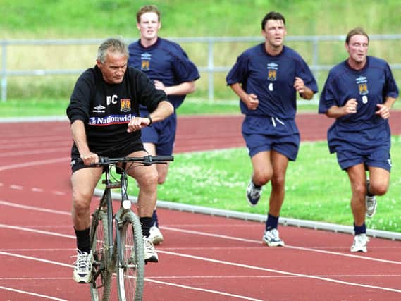 Ian Sampson is put through his paces by Denis Casey in a pre-season on the old Sixfields athletics track