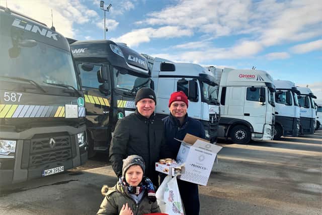 NN1 Personnel director Damian Sodel with his seven-year-old son, Alexander, and driver Andrzej Swietochowski delivering gifts last year