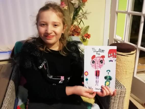 Holly Soorty, aged seven, with her published book.