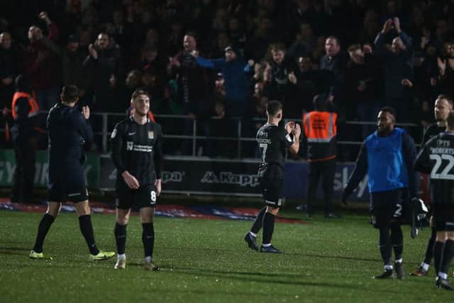 Cobblers celebrate with their fans after winning at Salford City last season.