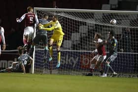 Cian Bolger rises highest to head home the Cobblers' winning goal (Picture: Pete Norton)