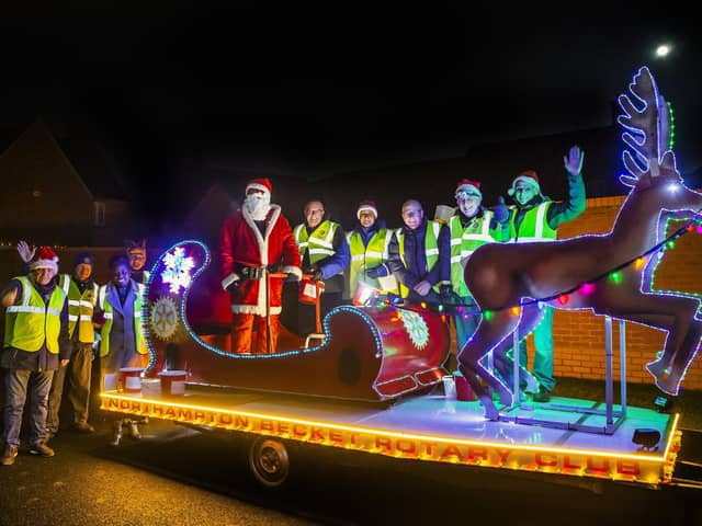 Santa pictured in Roade last year with his helpers. Pictures by Kirsty Edmonds.