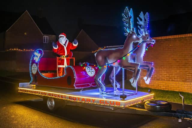 Santa pictured on his sparkly sleigh as he made his journey across town with his famous reindeers.