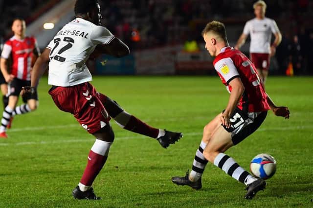 Benny Ashley-Seal drills home the Cobblers' winning goal at Exeter City (Pictures: Pete Norton)