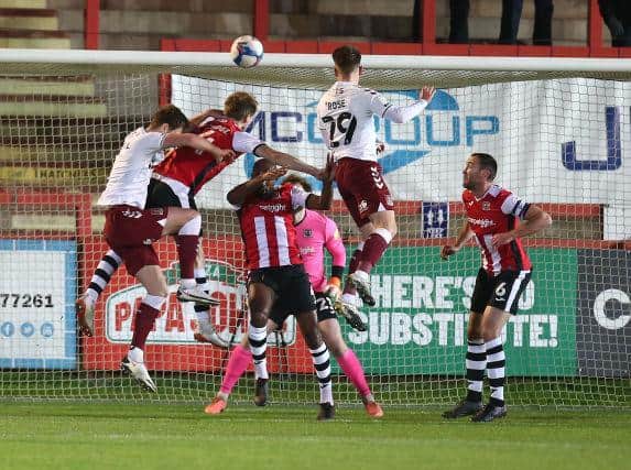 Danny Rose heads home his goal for the Cobblers at Exeter on Tuesday