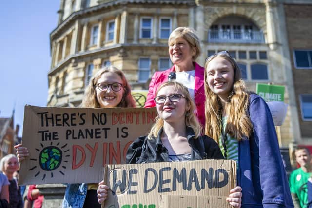 Eco March protestors, Mia Joice, Lorna Lewis and Ava Joice, pictured in Northampton, in September 2019, with former Labour MP candidate Sally Keeble after making an impassioned speech. Pictures by Kirsty Edmonds.
