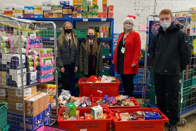 Moulton School and Science College students and a member of staff deliver the donations to Weston Favell foodbank