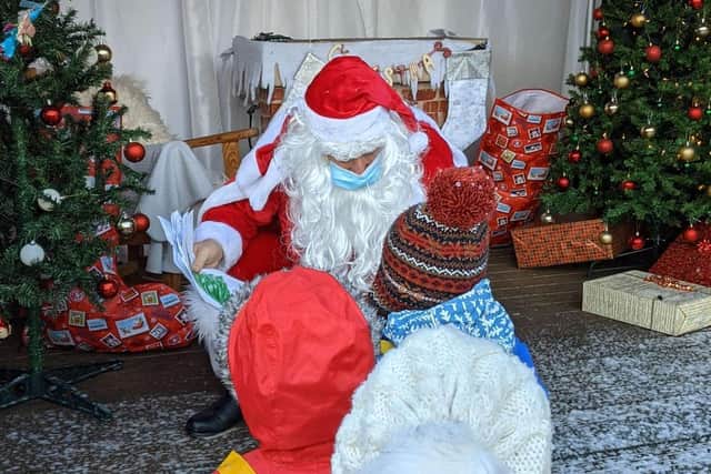Nicholas Hawksmoor Primary School pupils tell Father Christmas what they want for Christmas. Photo: Suzanne Kentish