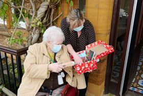 A St John's Residential Care Home resident opens her shoe box from the Northampton Dunelm store shoppers