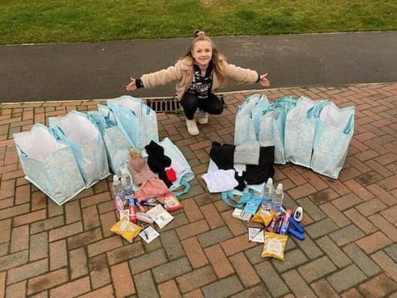 Isla pictured with her care packages, which she fundraised for herself.