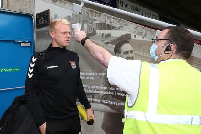 Jonathan Mitchell has his temperature taken.