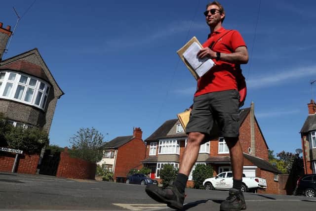 A Royal Mail postman on his daily round in Northampton in April during the first lockdown. Photo: Getty Images