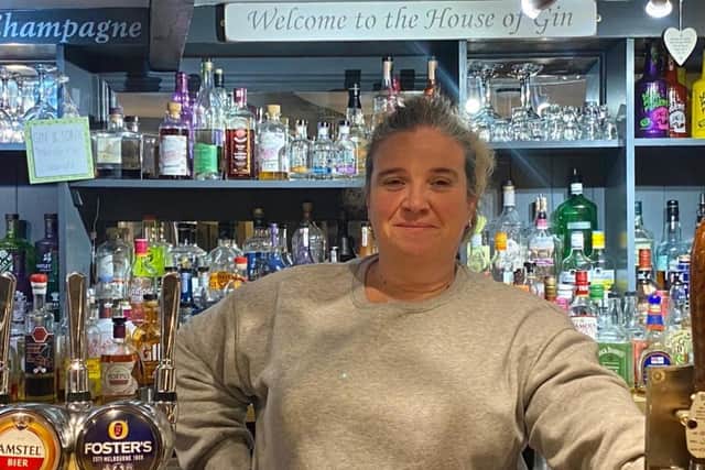 Miranda Clare behind the bar at The Live and Let Live pub in Harpole