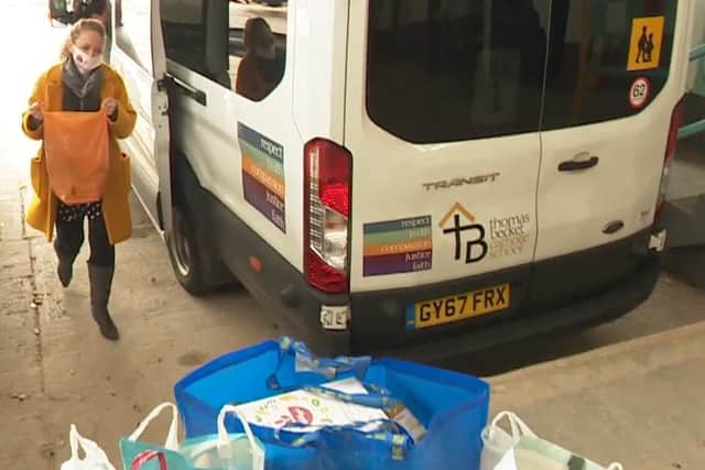 A Thomas Becket Catholic School member of staff drops off donations at Northampton Hope Centre from the school's foodbank