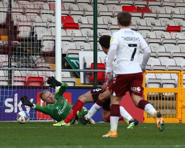 Jonathan Mitchell makes an excellent close-range save from Joe Walsh in the first-half of Saturday's League One fixture at Sincil Bank. Pictures: Pete Norton.