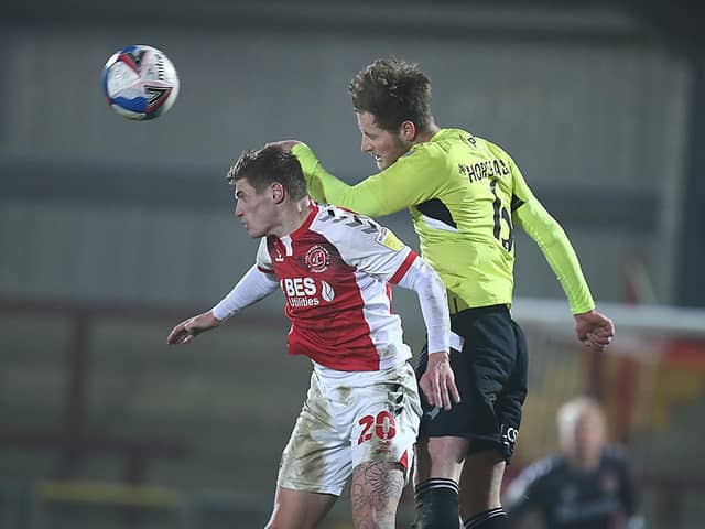 Fraser Horsfall beats Fleetwood's Harvey Saunders in the air (Picture: Pete Norton)