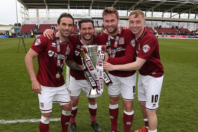 Nicky Adams (right) savours the Cobblers' 2016 title with with (from left) Ricky Holmes, David Buchanan and Joel Byrom
