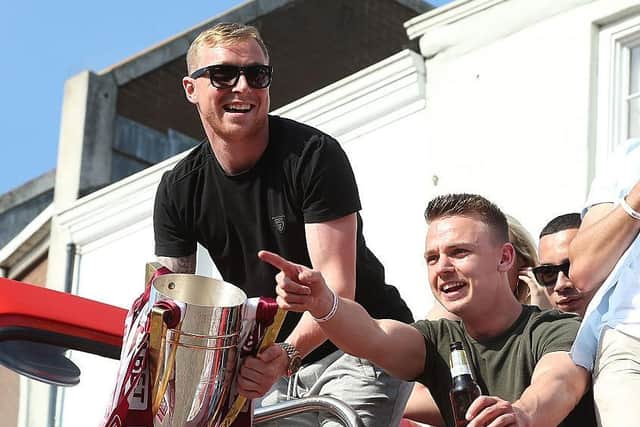 Nicky Adams enjoys the open top bus parade in Northampton following the league two title win in 2016